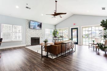 A living room with a fireplace and a tv mounted on the wall